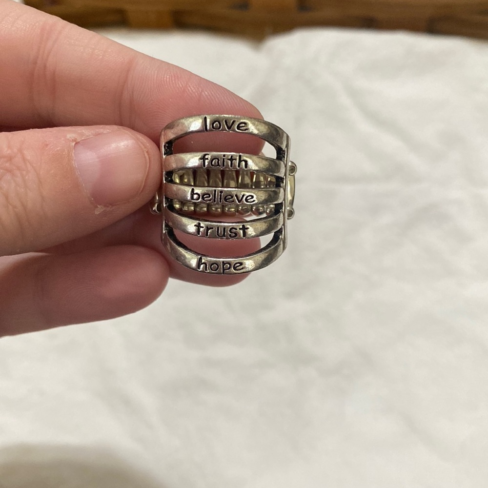 “love", "faith", "believe", "trust", & “hope". Silver ring with a stretchy band